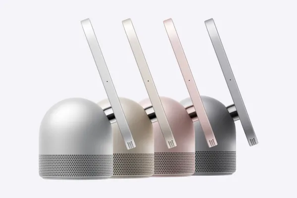 Four Apple HomeView smart displays shown from the side in silver, starlight, rose pink and space gray, each with its screen on a hinged arm above a round speaker base