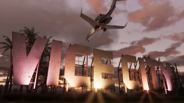 Official Grand Theft Auto VI screenshot: the weathered VICE CITY hillside sign lit from below at dusk, with a private jet flying overhead