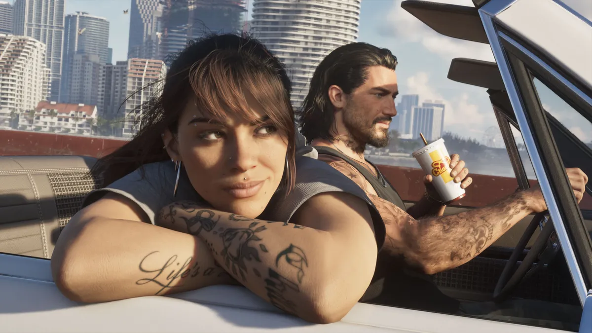 Official Grand Theft Auto VI screenshot: Lucia leans on the door of a convertible beside Jason, who holds a drink, with the Vice City skyline behind them