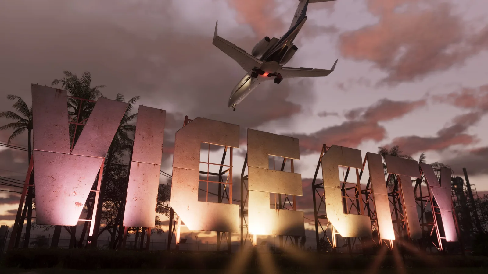 Official Grand Theft Auto VI screenshot: the weathered VICE CITY hillside sign lit from below at dusk, with a private jet flying overhead