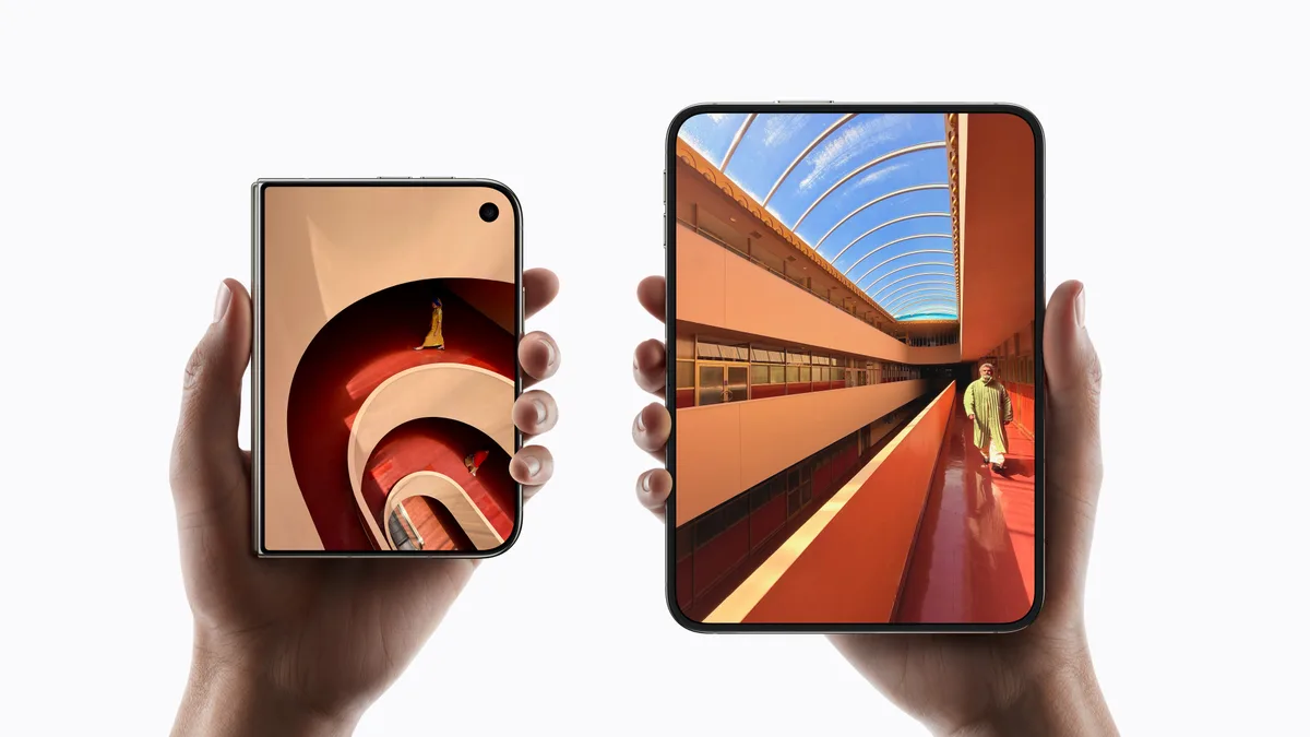 Two hands holding iPhone Duo phones, one closed with a spiral staircase photo on the outer display and one opened with a sunlit hallway photo on the inner display