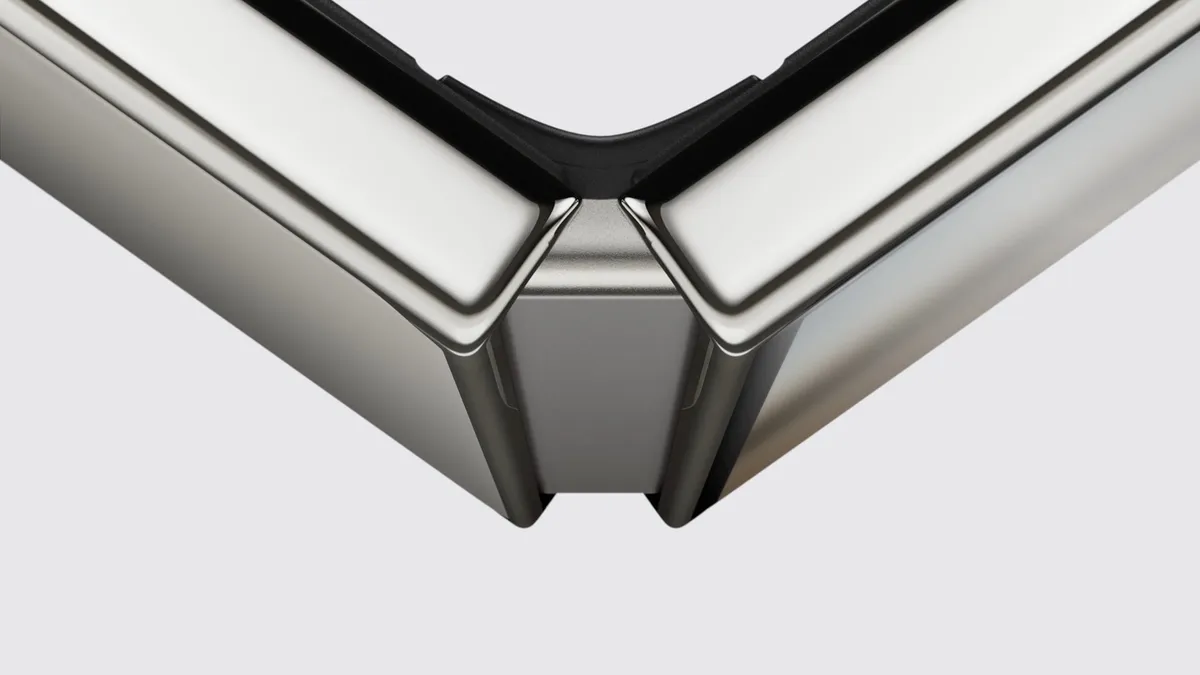 Close-up of the iPhone Duo's polished titanium frame and precision hinge, with the phone partly folded