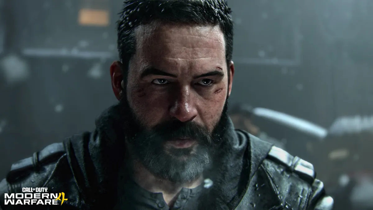 Close-up of Captain Price, bearded and wearing a dark jacket, outdoors in falling snow or rain, with the Call of Duty Modern Warfare 4 logo in the bottom-left corner