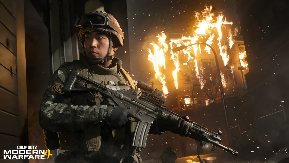 A soldier in a helmet and goggles holds a rifle at night beside a burning building, with the Call of Duty Modern Warfare 4 logo in the bottom-left corner
