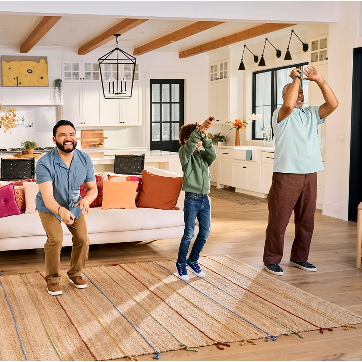 A man, a child and an older man playing Nintendo Switch Sports Resort with Joy-Con 2 controllers in a bright living room